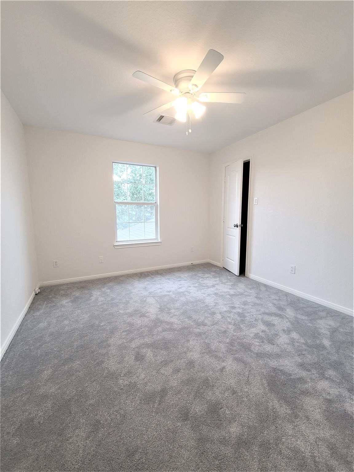 10026 Gil Jr Lane Houston, TX 77075 - Photo 10 of 14 an empty room with windows and fan