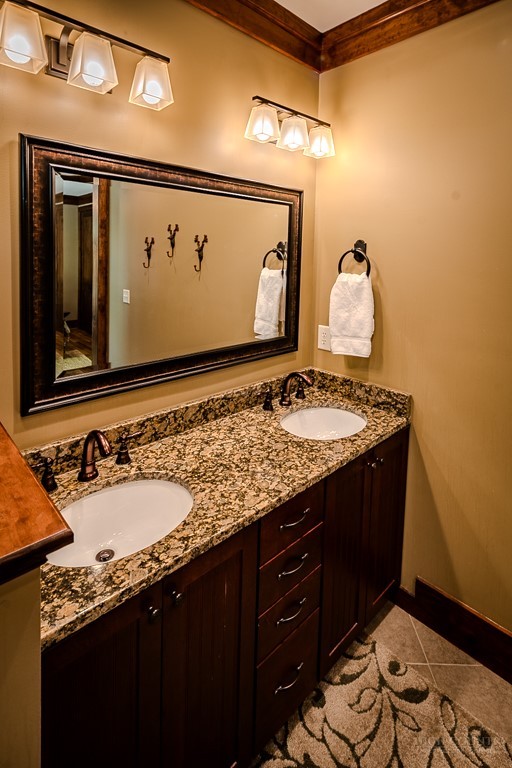 485 Woodlake Loop Road Elk Park, NC 28622 - Photo 16 of 44 a bathroom with a granite countertop sink and a mirror