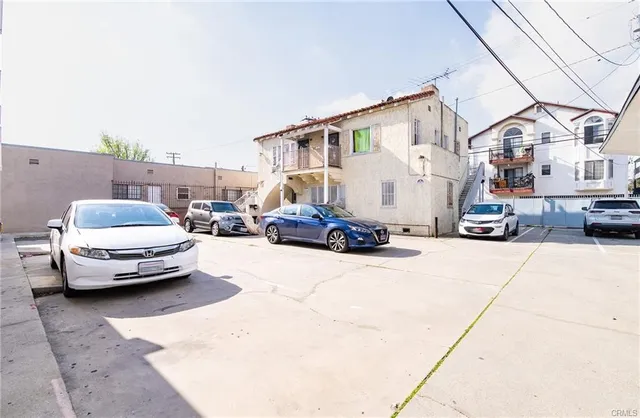 a car parked in front of a white house
