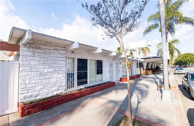 a view of a patio with table and chairs and potted plants