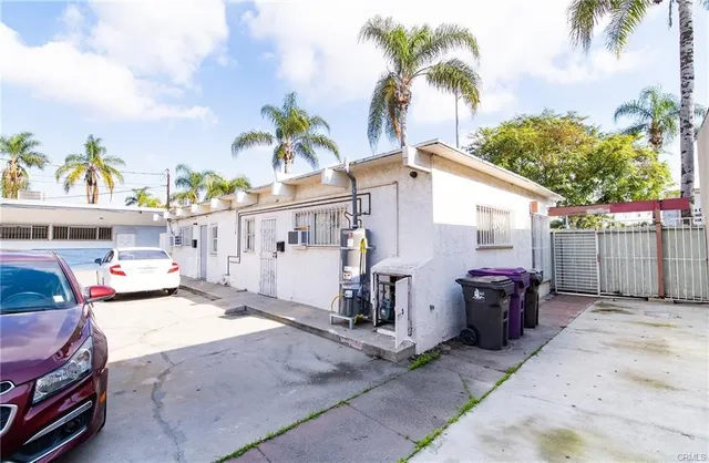 a view of a house with backyard and sitting area