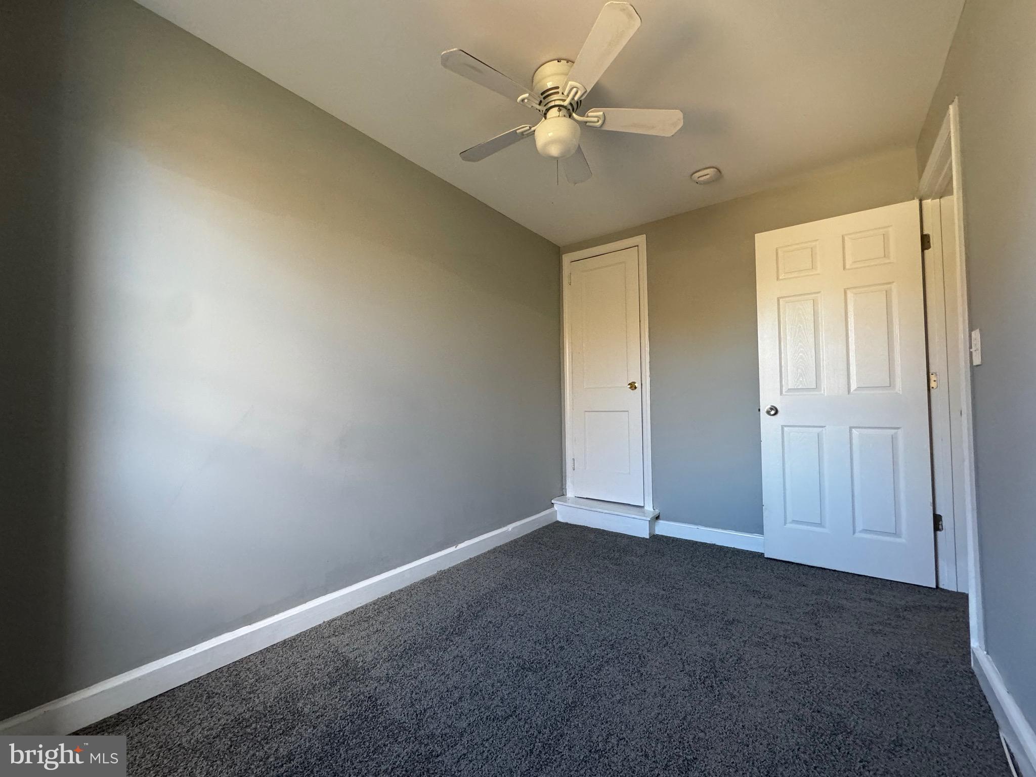 320 Sollers Point Road Dundalk, MD 21222 - Photo 13 of 16 an empty room with a ceiling fan and a window