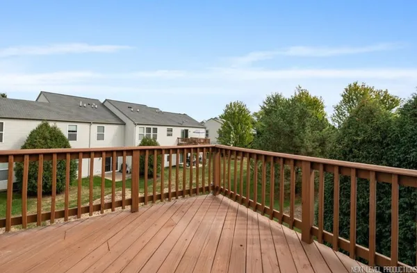 a balcony with wooden floor and fence
