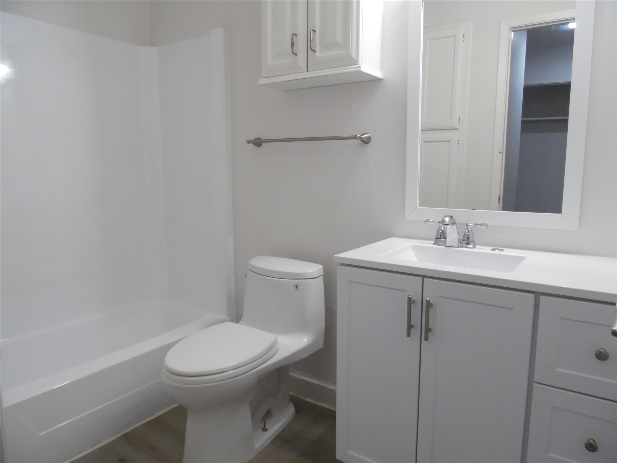 7400 Dixie Drive, Unit B Austin, TX 78744 - Photo 14 of 15 Bathroom featuring a white vanity with a rectangular sink, a framed mirror, and a white bathtub with a shower