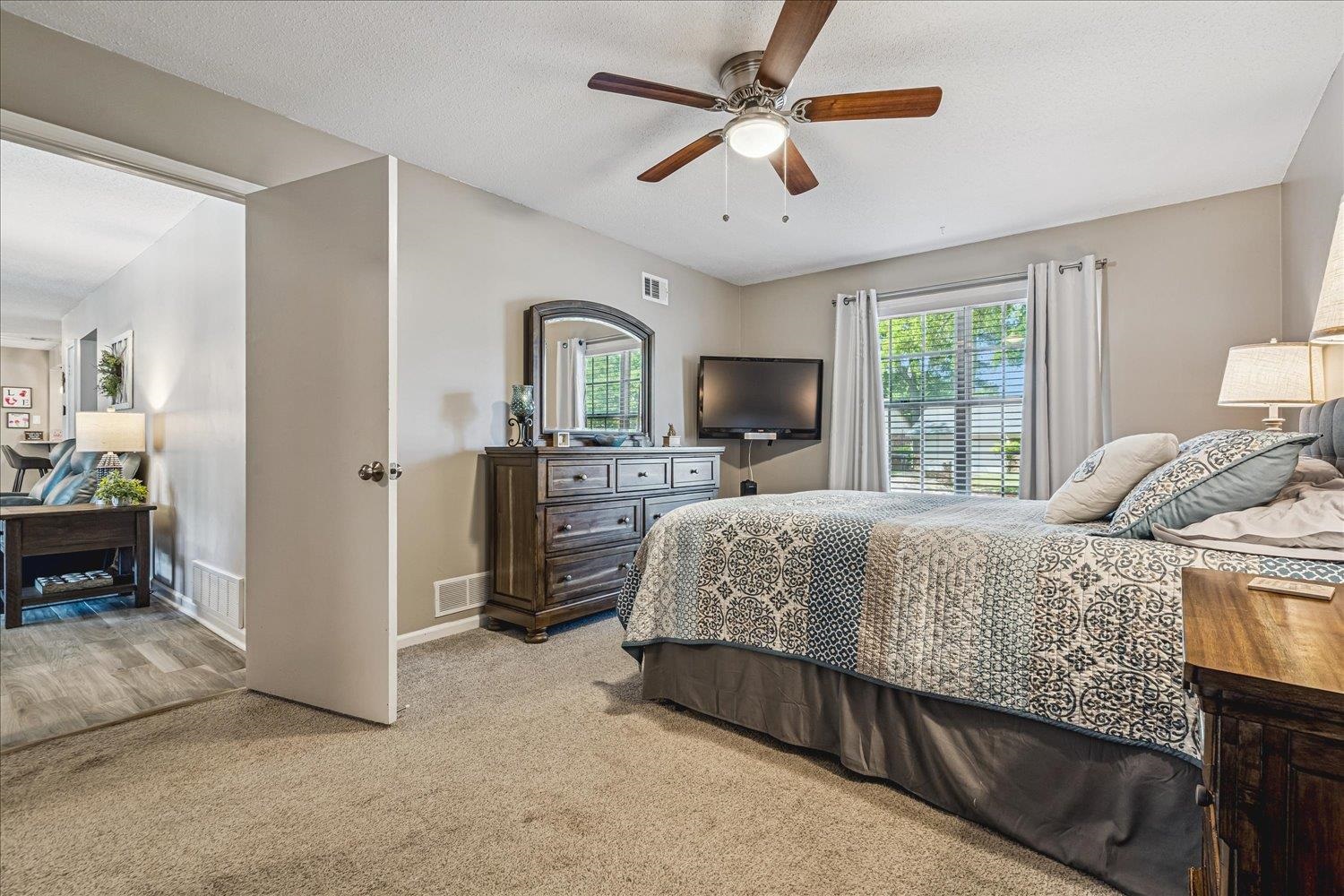 2944 Charles Bryan Road Bartlett, TN 38134 - Photo 18 of 36 a bedroom with a bed dresser and a flat screen tv