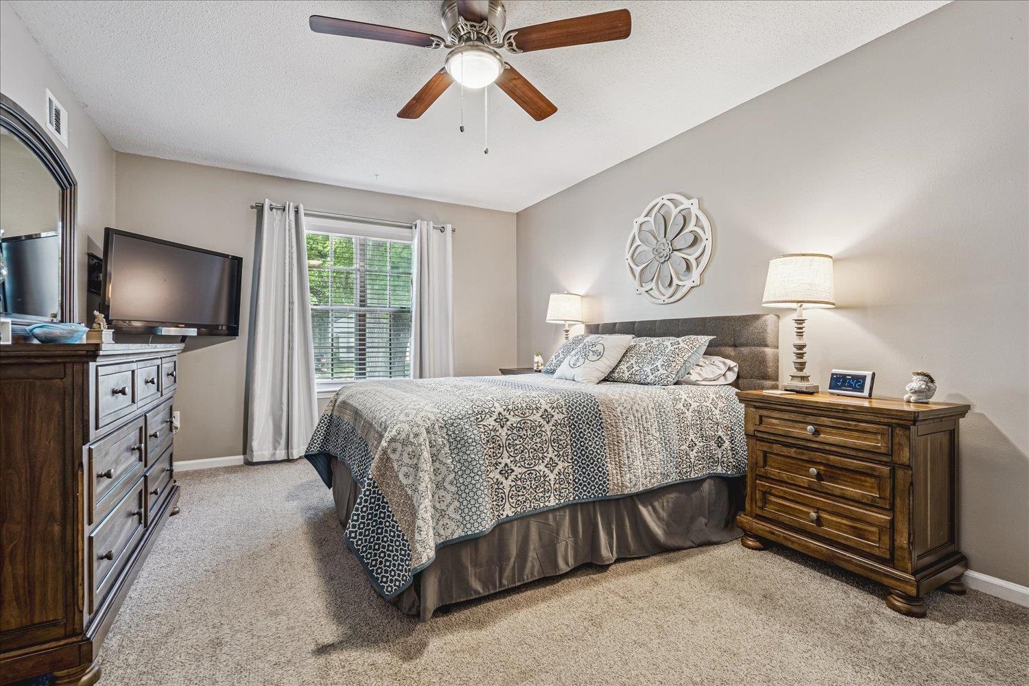 2944 Charles Bryan Road Bartlett, TN 38134 - Photo 19 of 36 a bedroom with a bed and a flat tv screen on a dresser