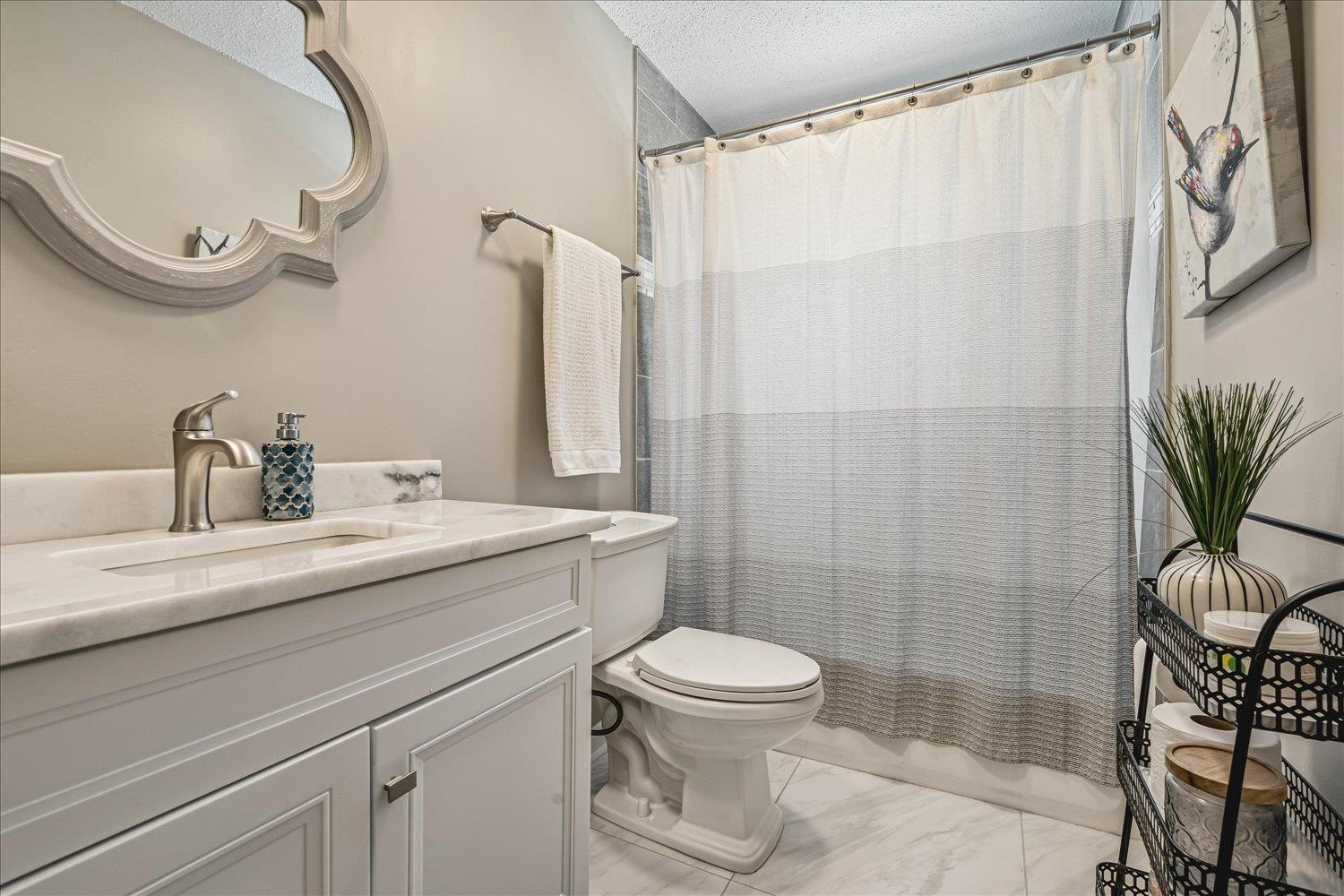 2944 Charles Bryan Road Bartlett, TN 38134 - Photo 22 of 36 a bathroom with a granite countertop sink a toilet and shower