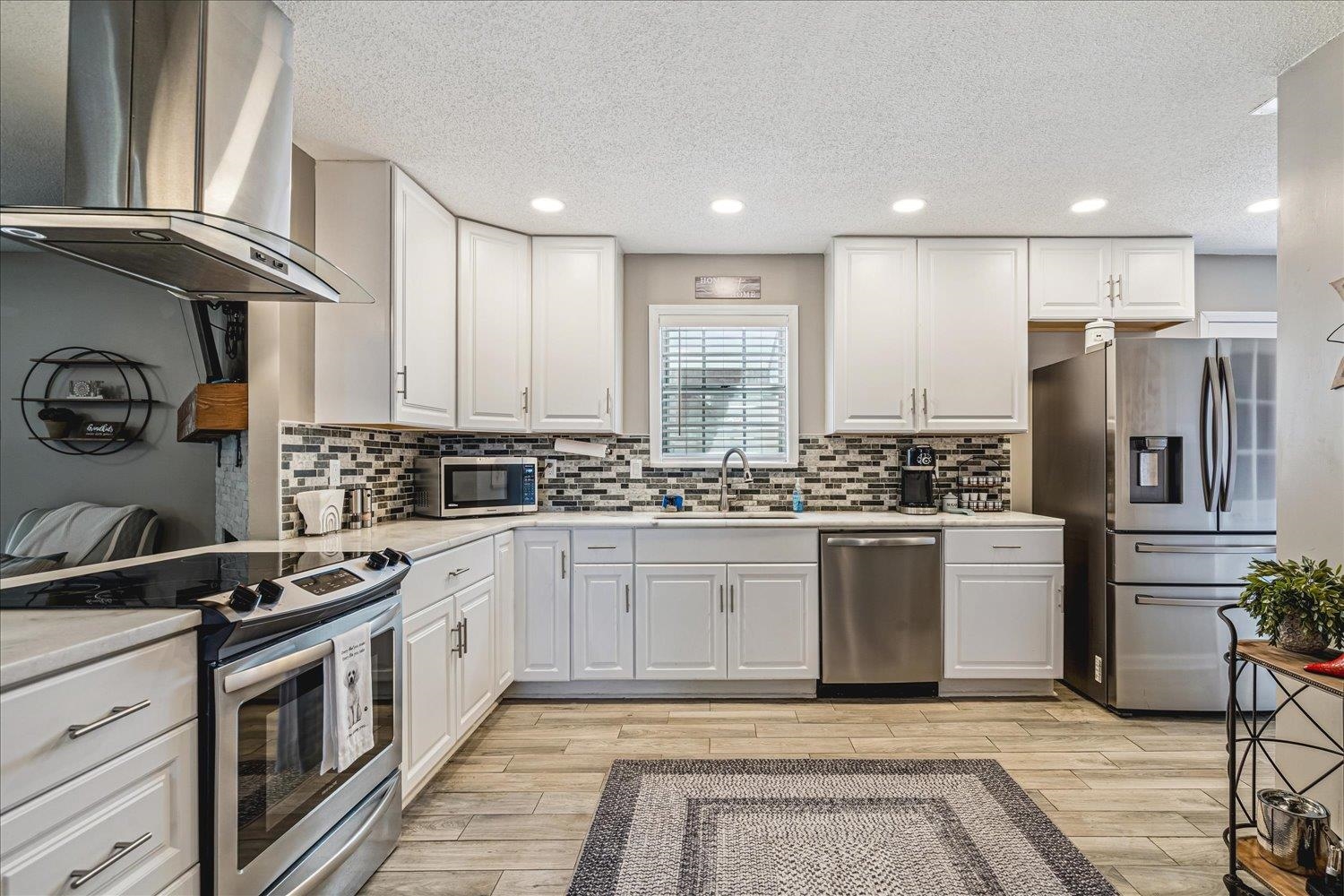 2944 Charles Bryan Road Bartlett, TN 38134 - Photo 9 of 36 a kitchen with a sink stainless steel appliances and cabinets