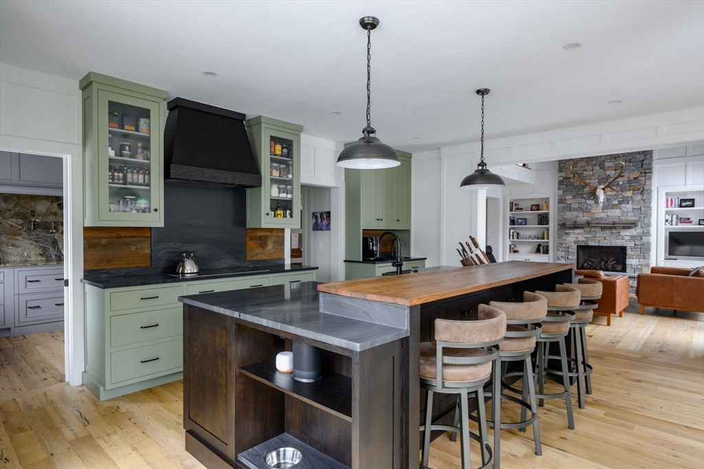 9 Tillinghast Drive Hingham, MA 02043 - Photo 14 of 39 a kitchen with stainless steel appliances granite countertop a stove a refrigerator a kitchen island a dining table and chairs