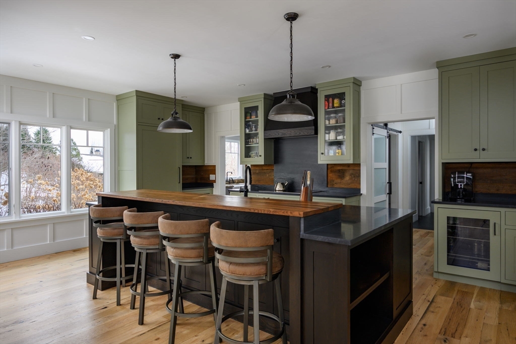 9 Tillinghast Drive Hingham, MA 02043 - Photo 9 of 39 a kitchen with stainless steel appliances a sink a stove a refrigerator a center island and a wooden floor