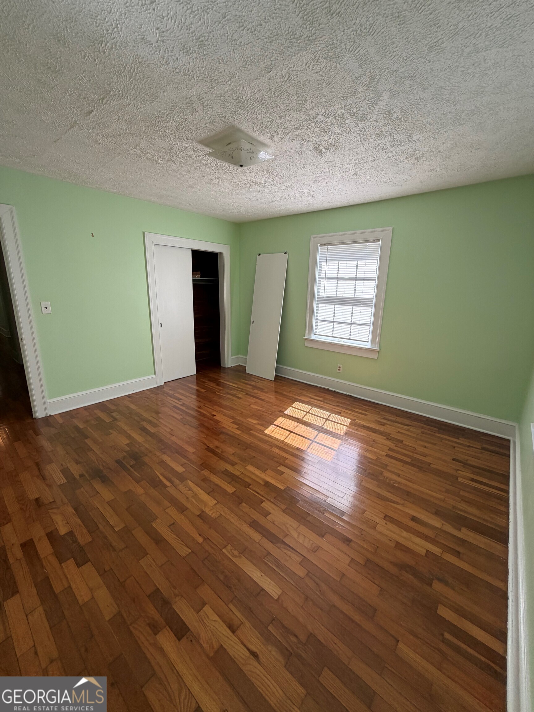 2619 Maple Road Southeast Rome, GA 30161 - Photo 28 of 31 a view of an empty room with window and wooden floor