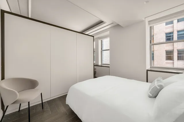 a bedroom with a bed and a chair