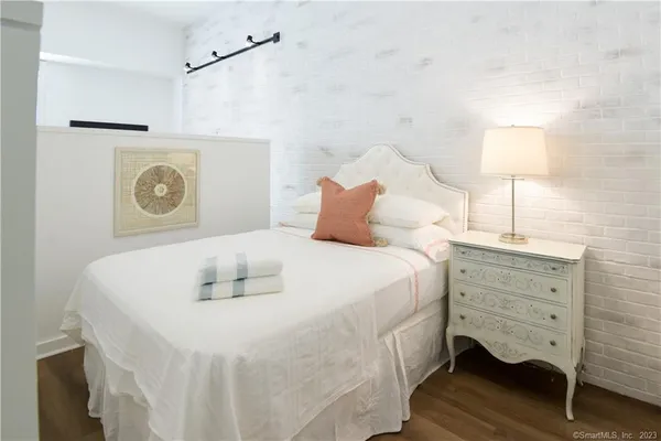 a bedroom with a bed and a lamp
