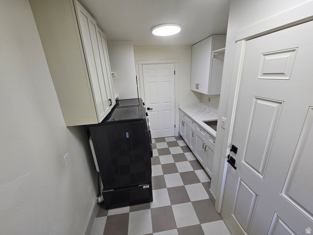 812 East Bates Cyn Road Tooele, UT 84074 - Photo 49 of 144 Utility room featuring checkerboard flooring, white cabinetry, a built-in sink, and white paneled doors
