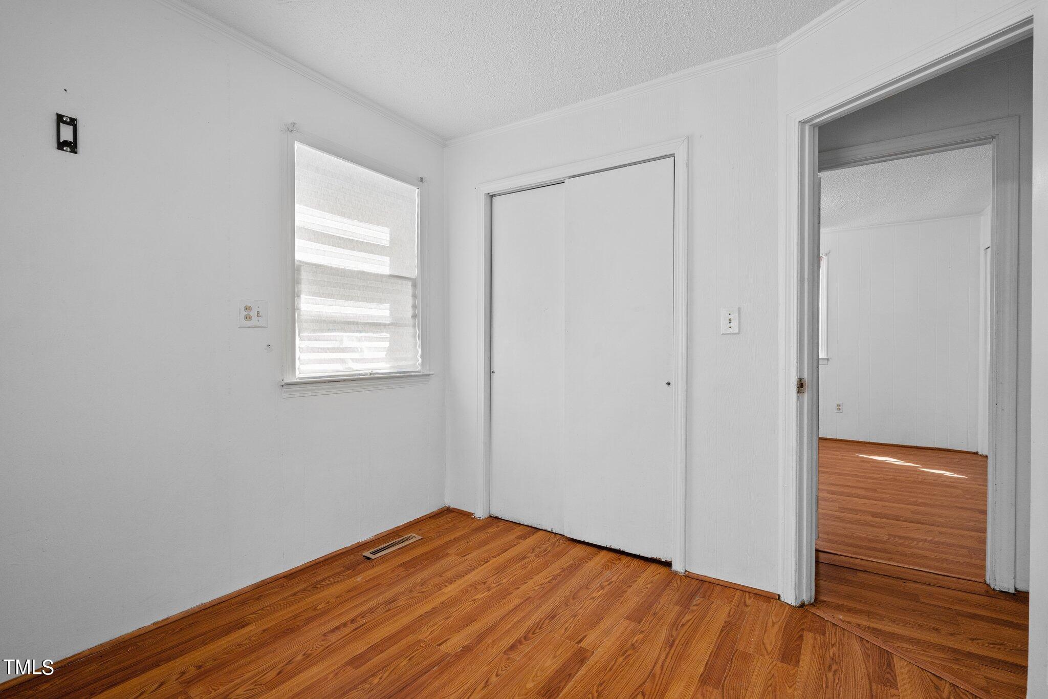 223 Gentry Street Roxboro, NC 27573 - Photo 18 of 36 a view of empty room with wooden floor and fan
