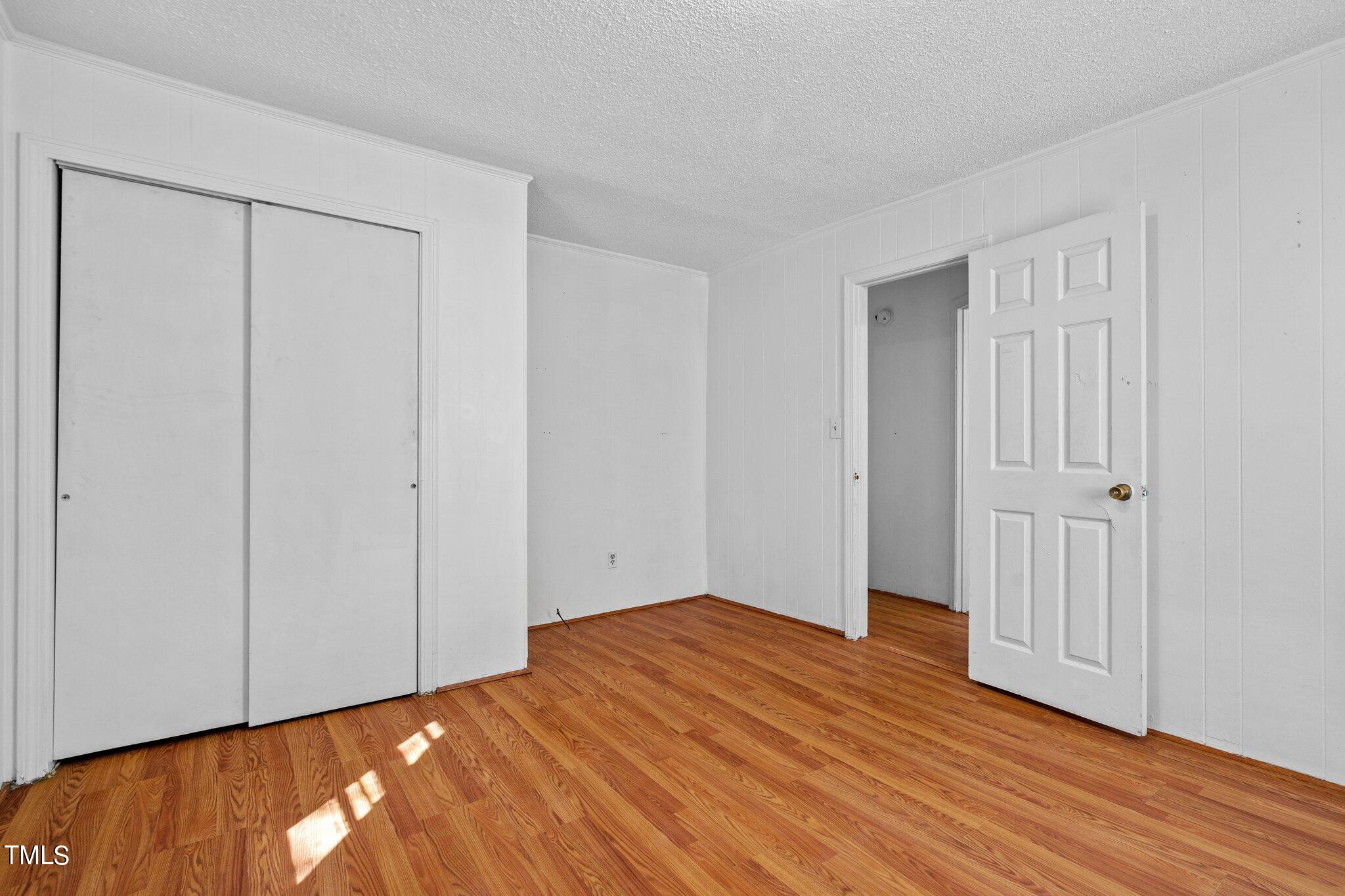223 Gentry Street Roxboro, NC 27573 - Photo 21 of 36 a view of empty room with wooden floor