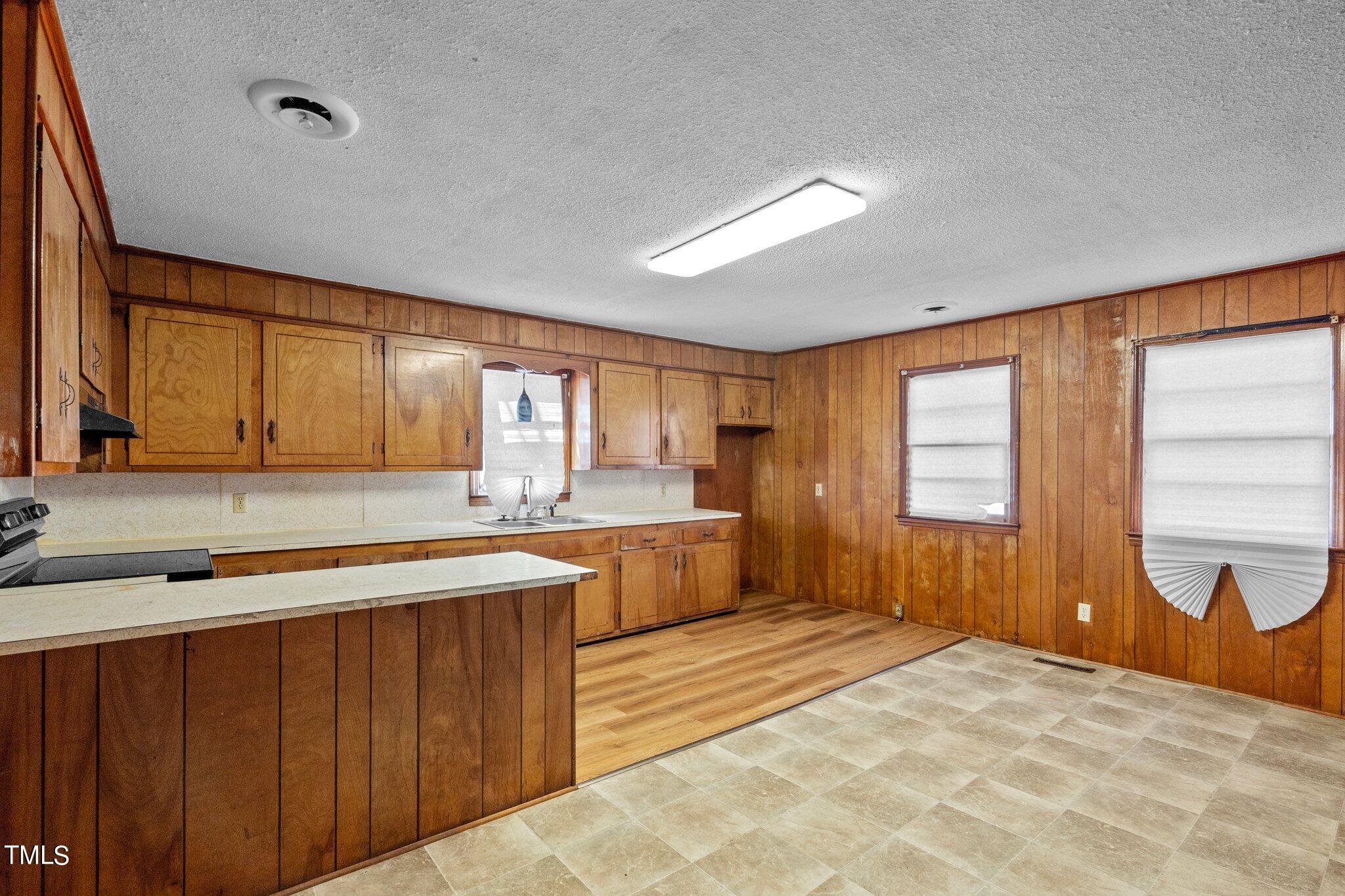 223 Gentry Street Roxboro, NC 27573 - Photo 7 of 36 a large kitchen with a large window and stainless steel appliances