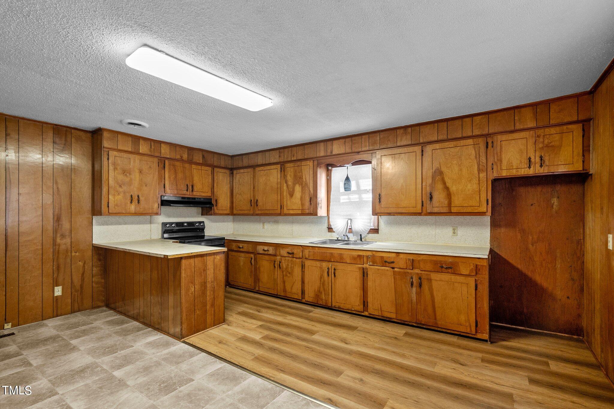 223 Gentry Street Roxboro, NC 27573 - Photo 8 of 36 a large kitchen with stainless steel appliances granite countertop a stove a sink dishwasher and a refrigerator