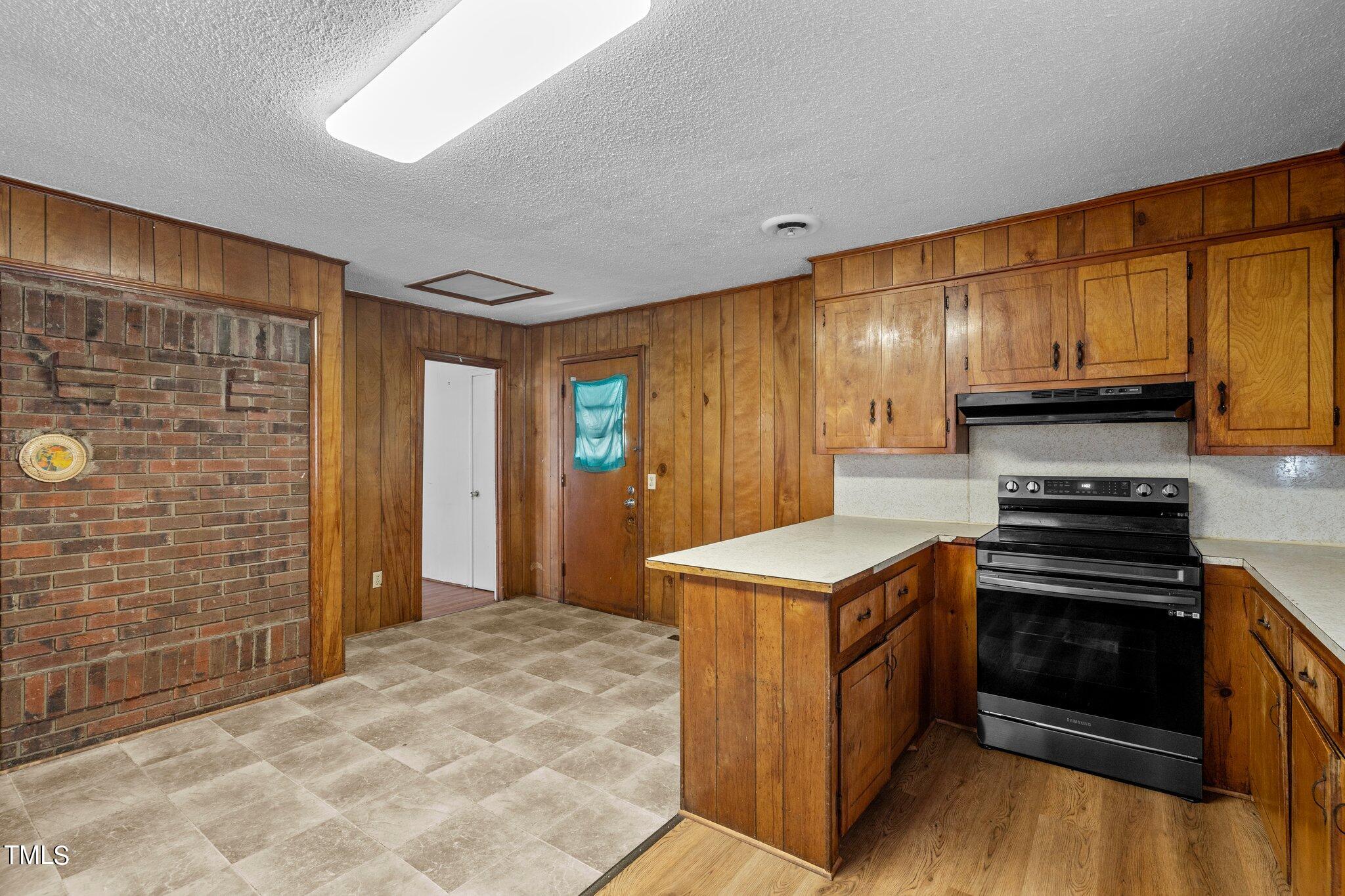 223 Gentry Street Roxboro, NC 27573 - Photo 10 of 36 a kitchen with stainless steel appliances a stove a sink and a refrigerator