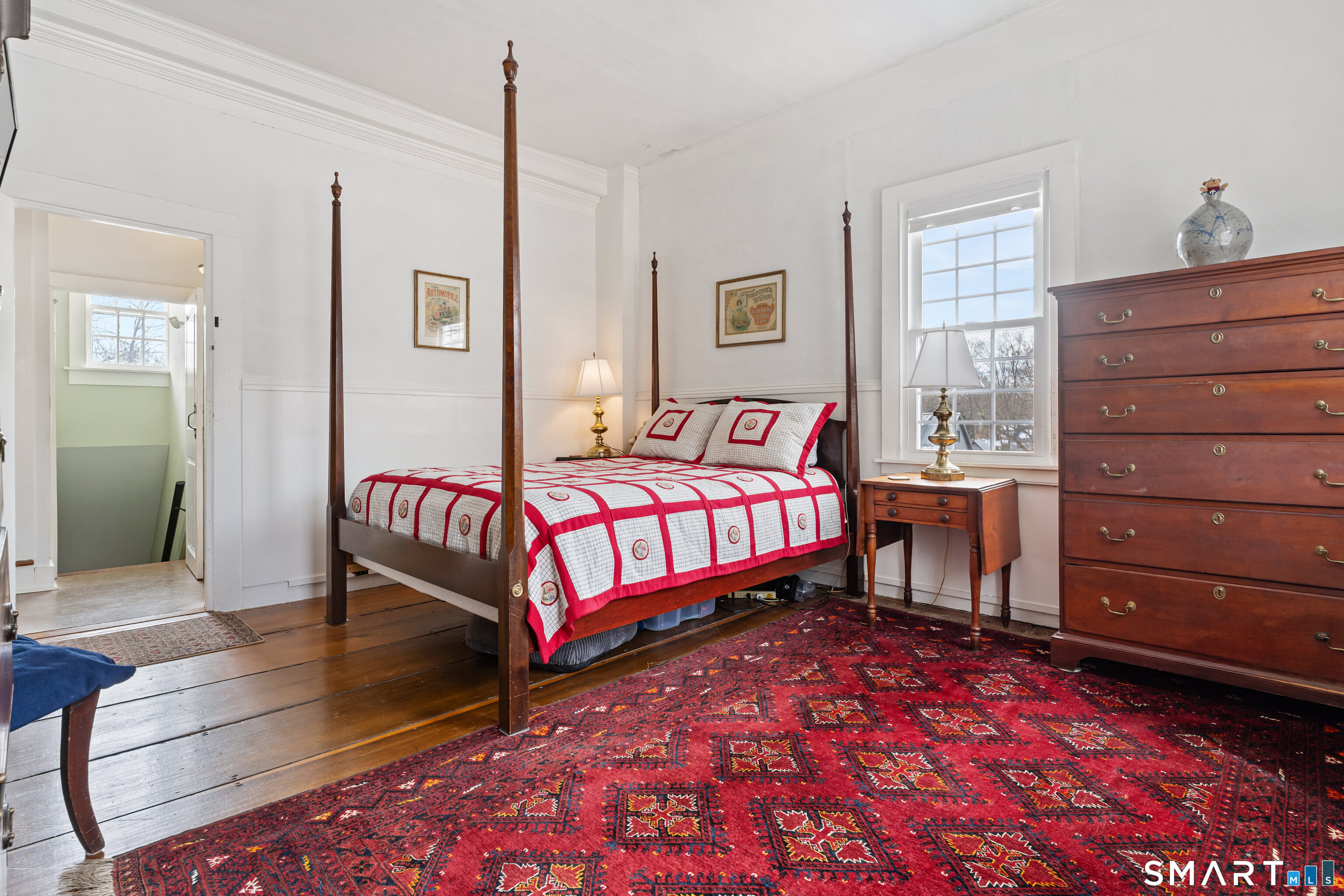 147 Boston Street Guilford, CT 06437 - Photo 11 of 32 a bedroom with a bed and a dresser