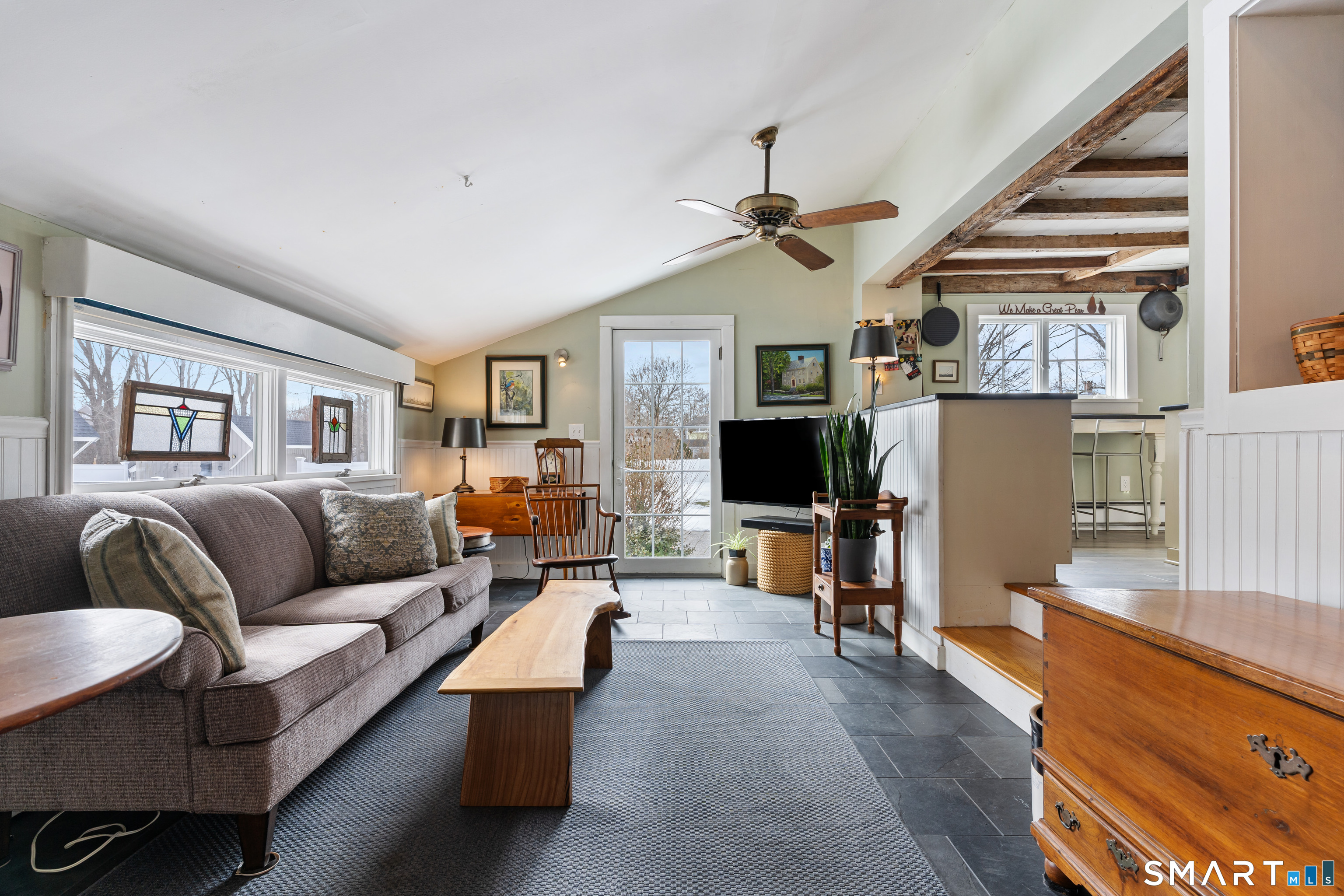 147 Boston Street Guilford, CT 06437 - Photo 15 of 32 a living room with furniture and a flat screen tv