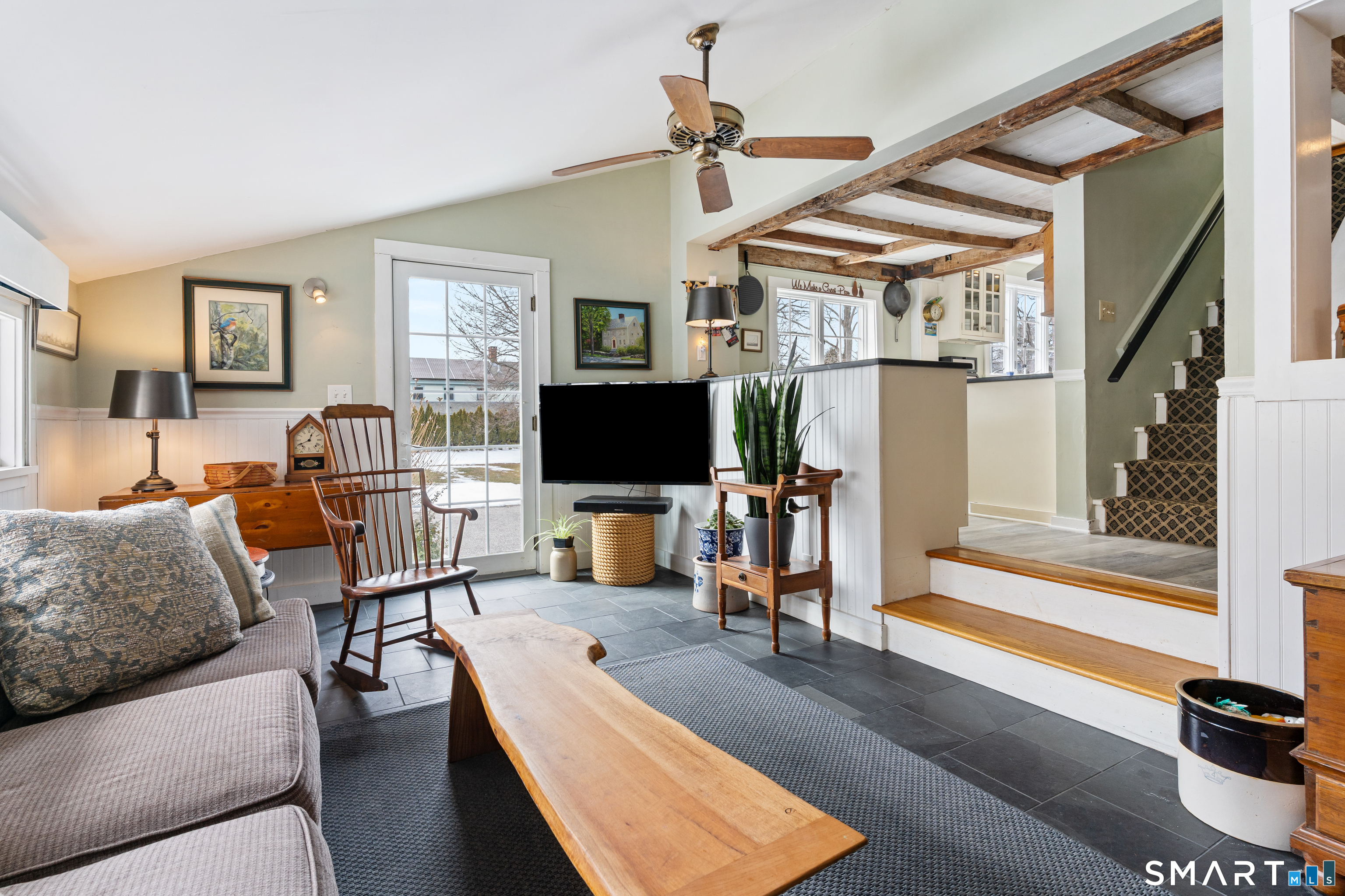 147 Boston Street Guilford, CT 06437 - Photo 16 of 32 a living room with furniture a flat screen tv and a window