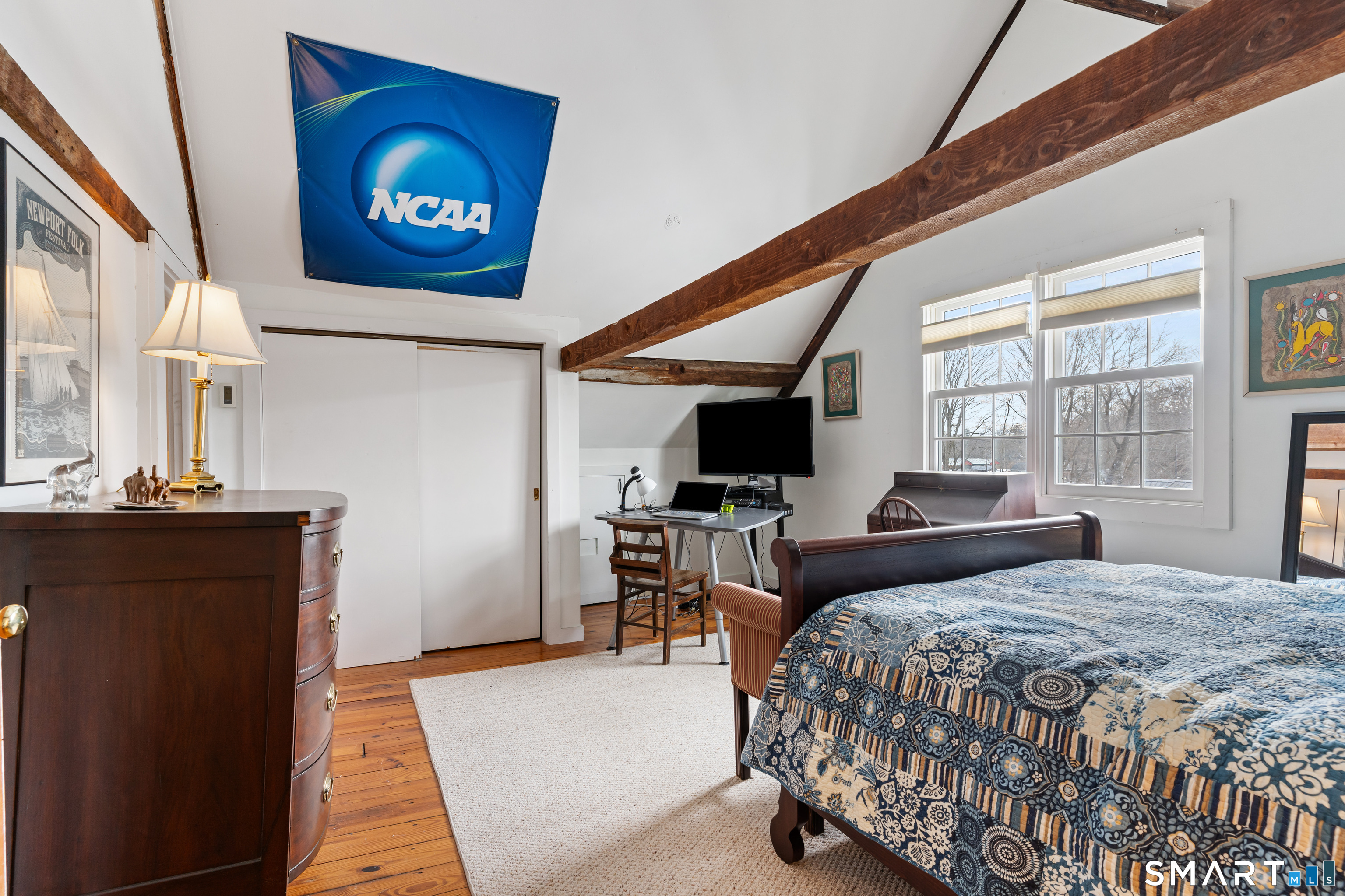 147 Boston Street Guilford, CT 06437 - Photo 18 of 32 a bedroom with a bed and a flat screen tv