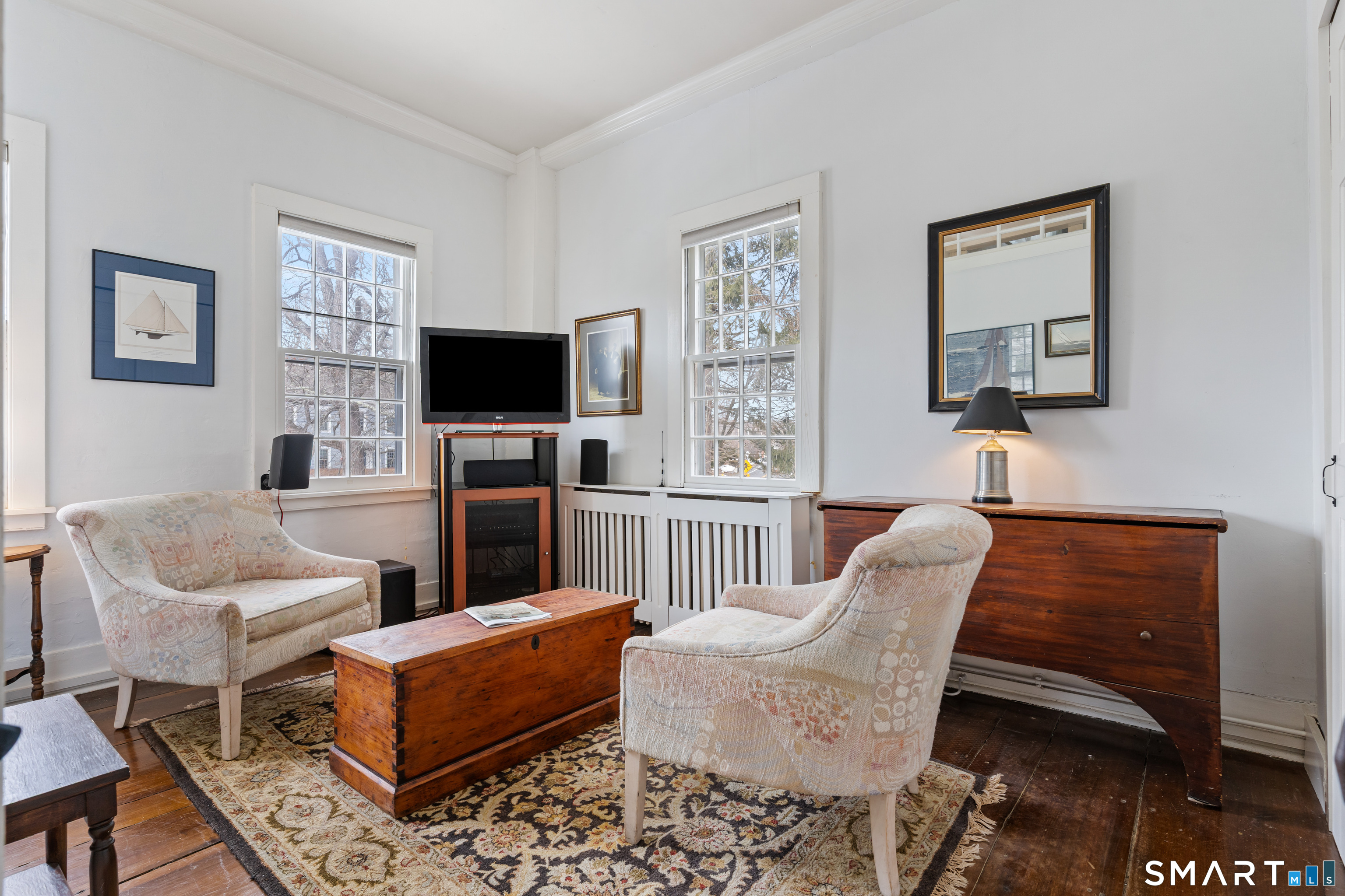 147 Boston Street Guilford, CT 06437 - Photo 23 of 32 a living room with furniture a flat screen tv and a wall painting