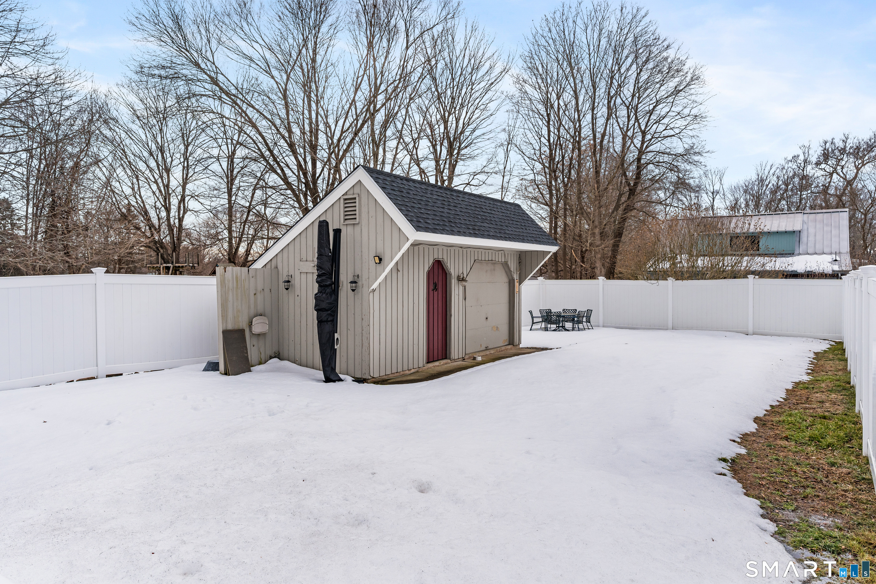 147 Boston Street Guilford, CT 06437 - Photo 29 of 32 a front view of a house with a yard covered with snow
