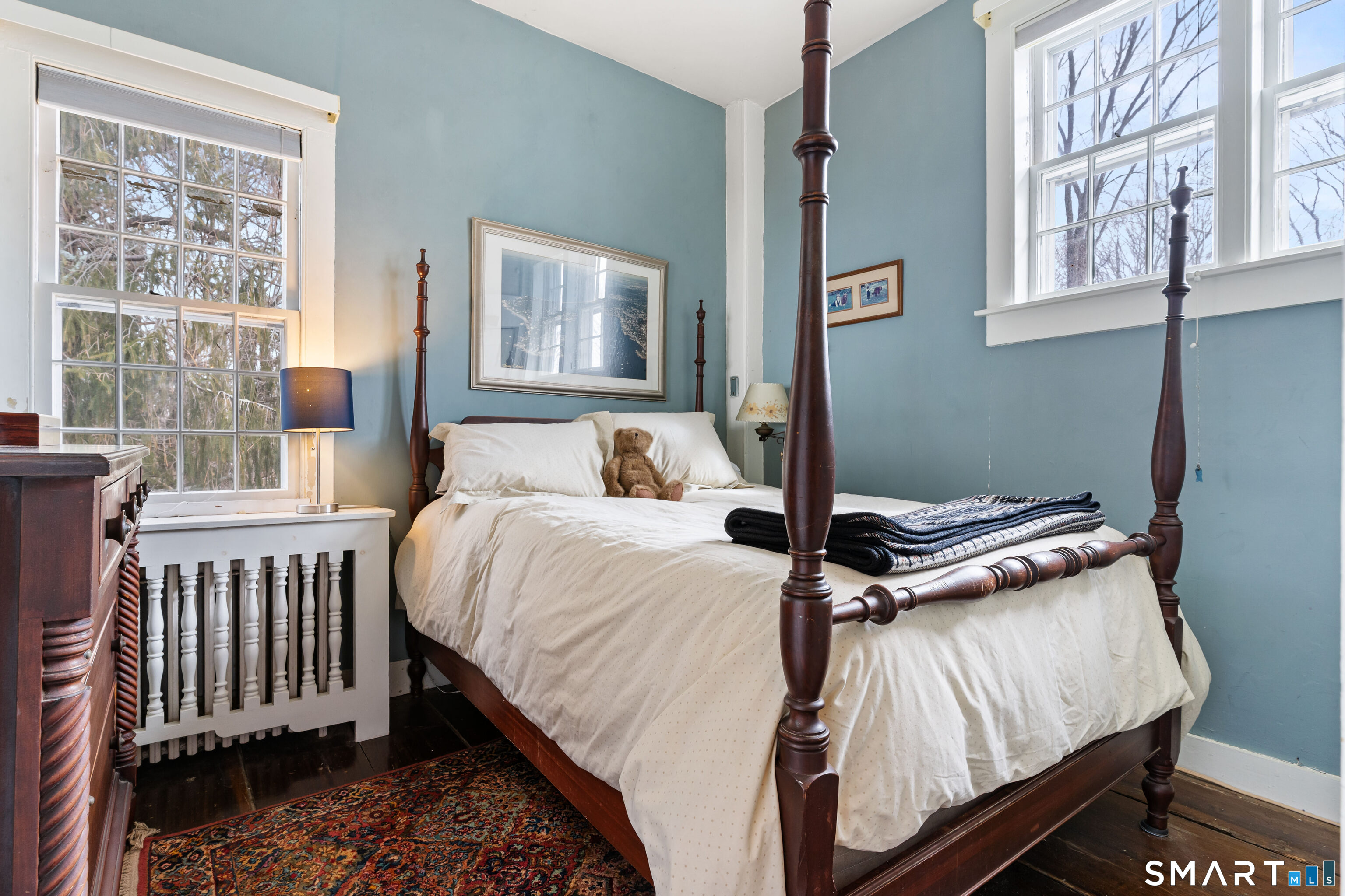 147 Boston Street Guilford, CT 06437 - Photo 29 of 38 a bedroom with a bed and wooden floor