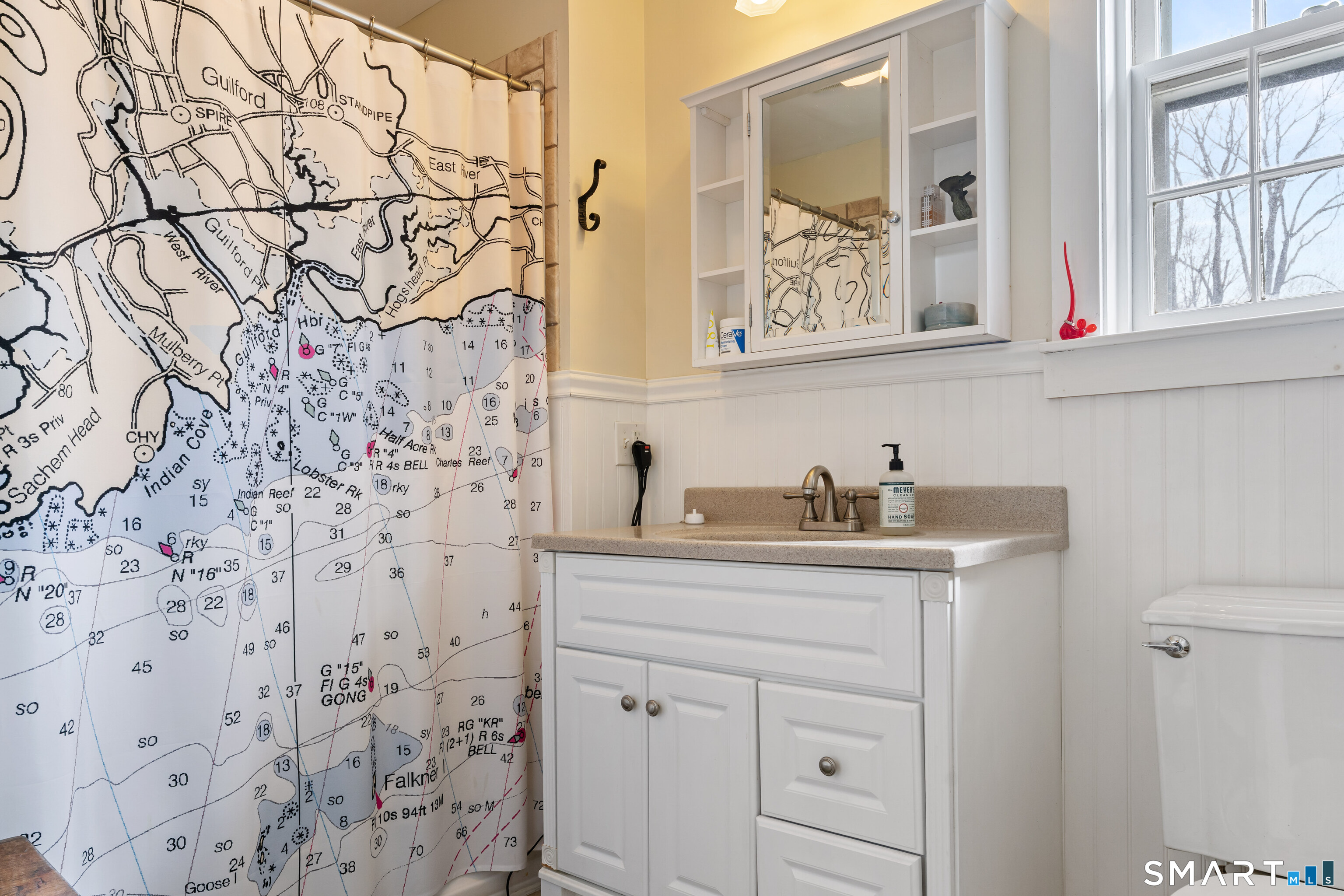 147 Boston Street Guilford, CT 06437 - Photo 30 of 38 a bathroom with a granite countertop sink and a mirror