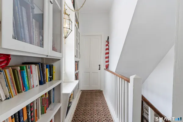 a view of a hallway with wooden floor and entryway