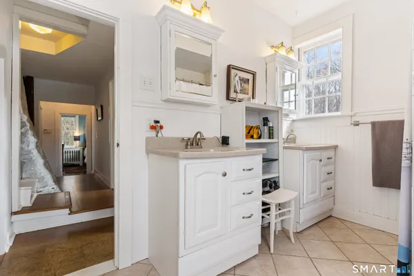 a kitchen with cabinets and chairs