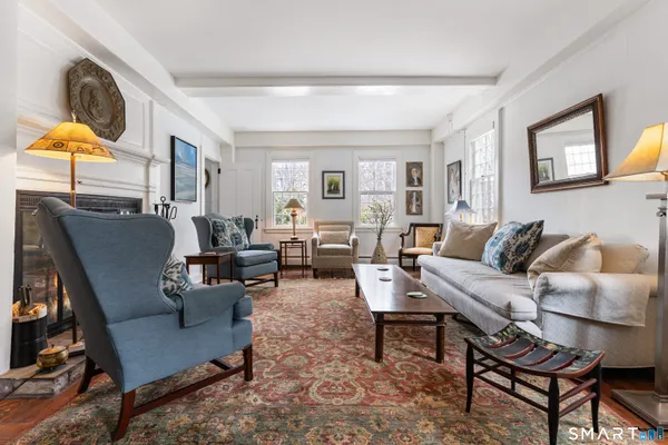 a living room with furniture a rug and a window