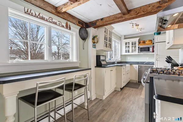 a kitchen with stainless steel appliances granite countertop a stove and cabinets