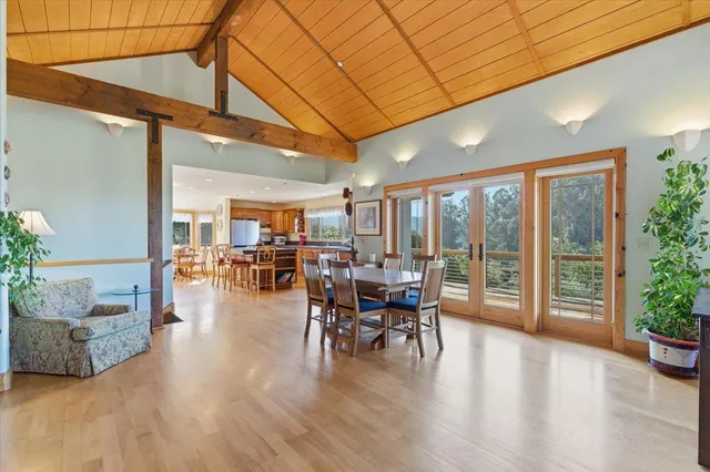 a dining room with furniture and wooden floor