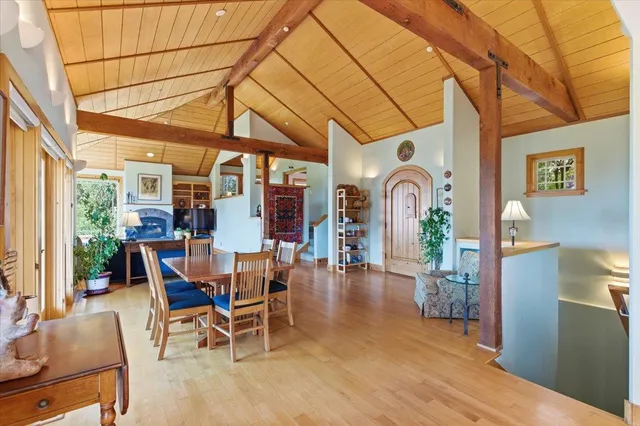 a living room with fireplace furniture and a large window