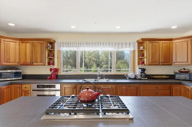 a kitchen with granite countertop a sink and a window
