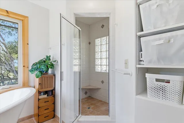 a dining room with furniture and large windows