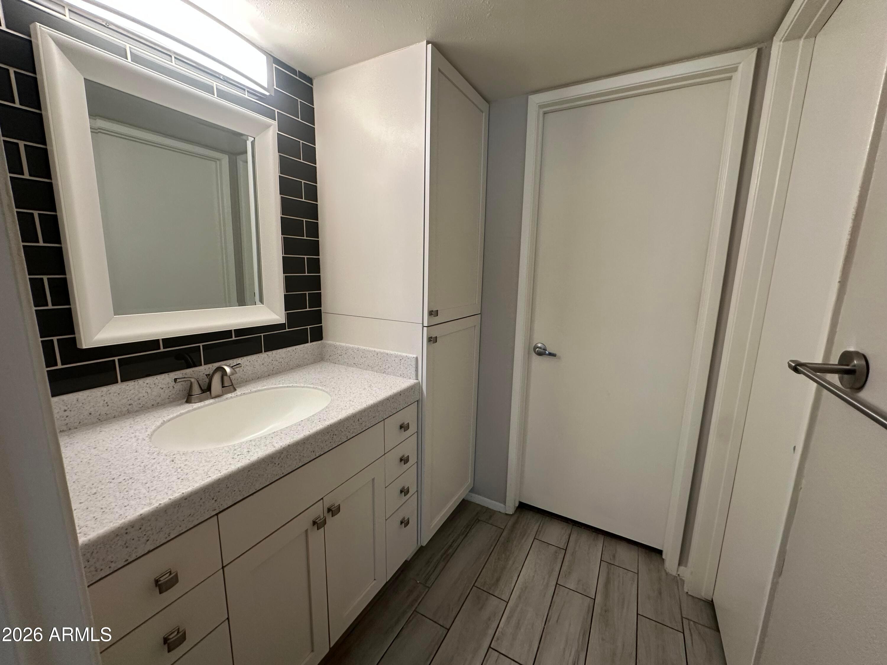 5525 East Thomas Road, Unit R8 Phoenix, AZ 85018 - Photo 11 of 21 a bathroom with a sink and a mirror