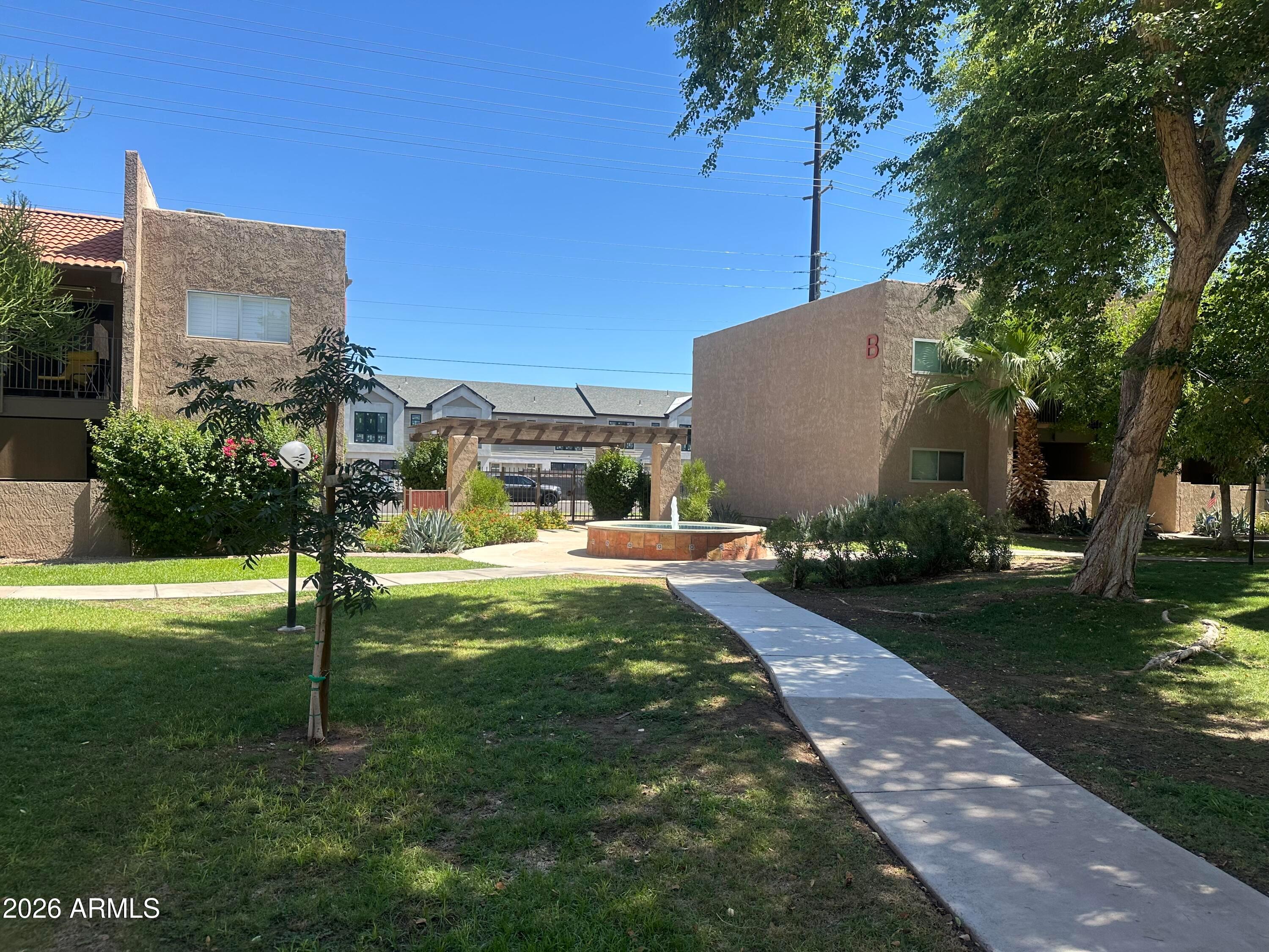 5525 East Thomas Road, Unit R8 Phoenix, AZ 85018 - Photo 2 of 21 a front view of a house with garden