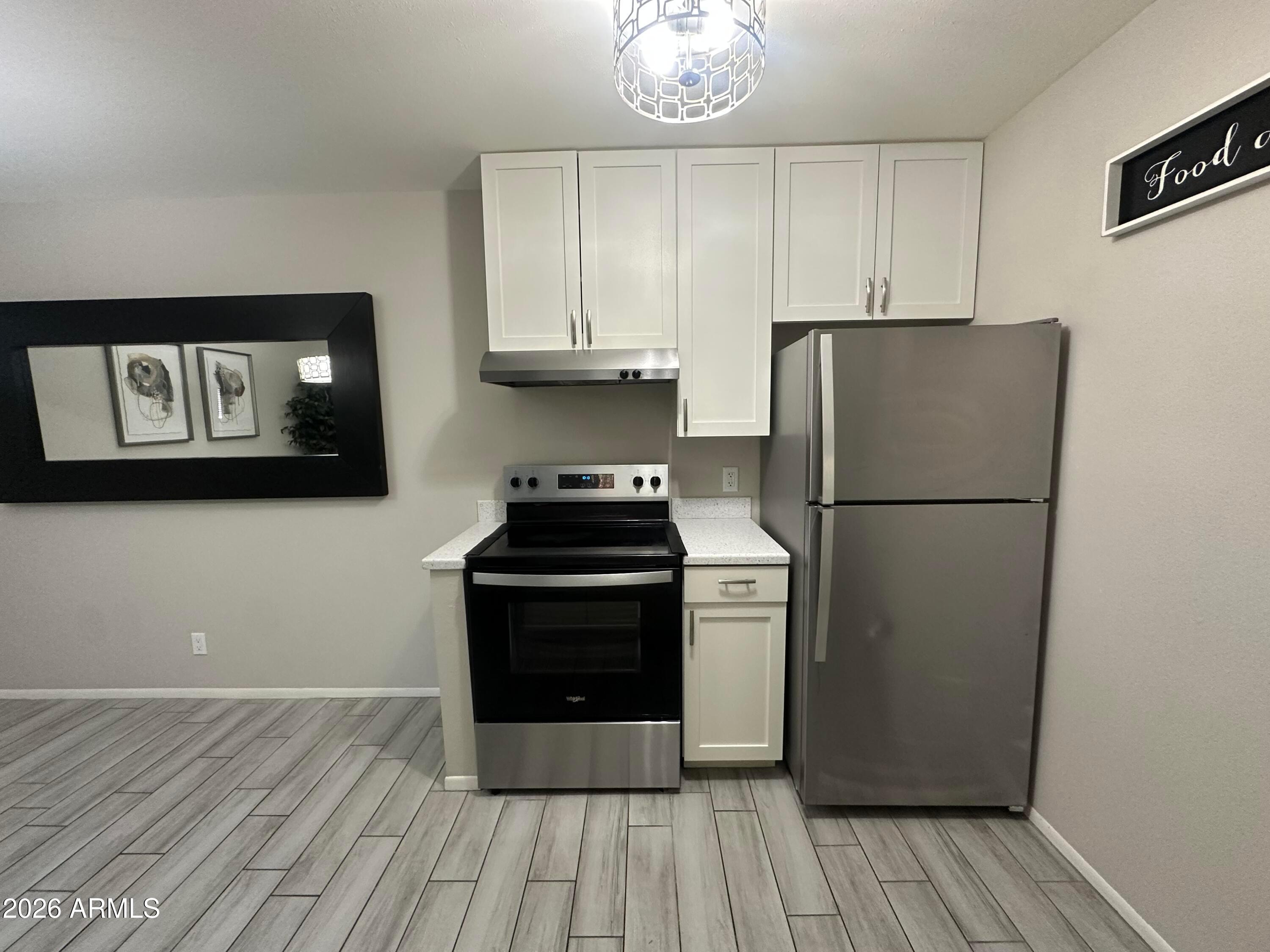 5525 East Thomas Road, Unit R8 Phoenix, AZ 85018 - Photo 4 of 21 a kitchen with a refrigerator and cabinets