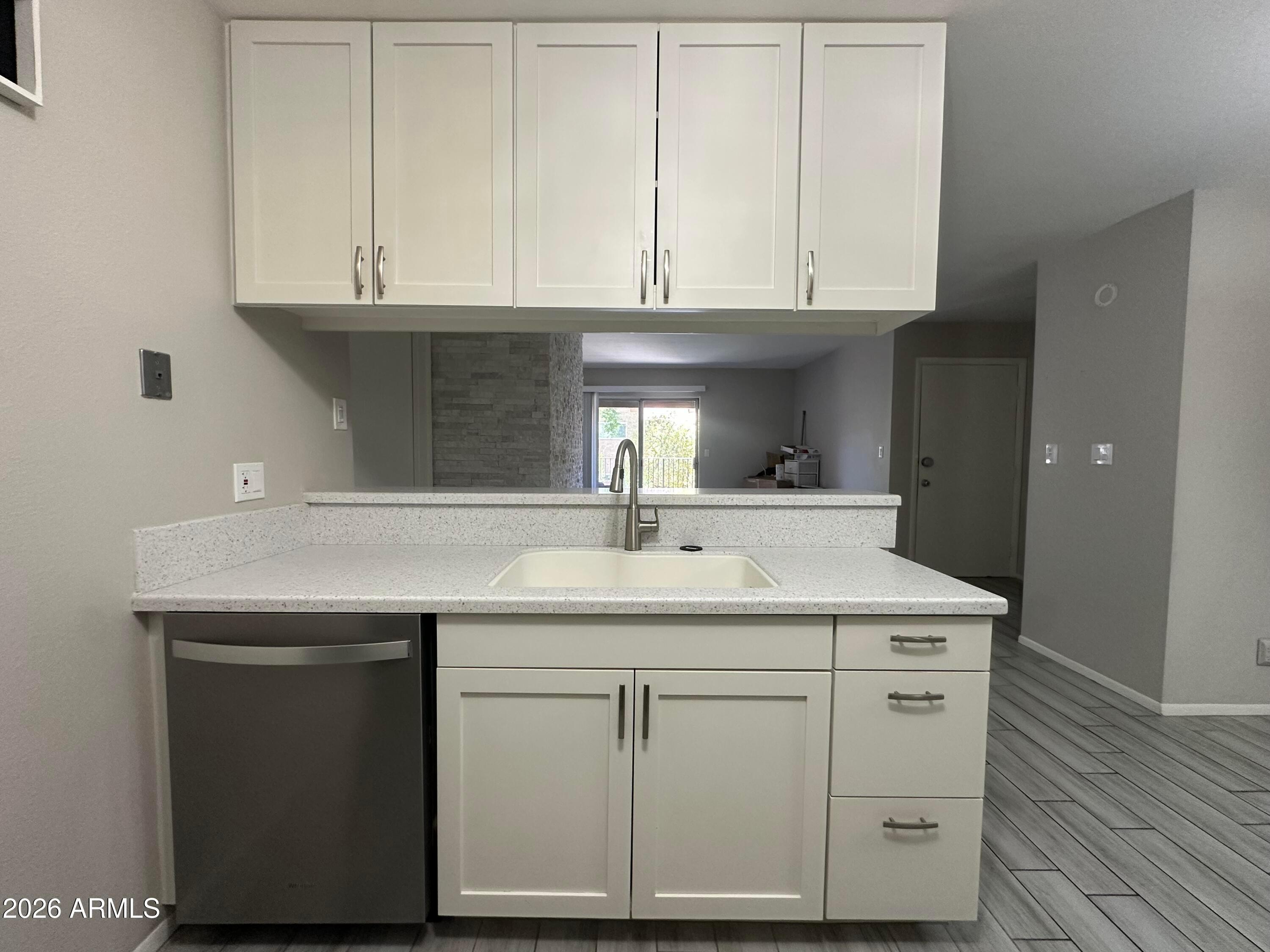 5525 East Thomas Road, Unit R8 Phoenix, AZ 85018 - Photo 6 of 21 a kitchen with granite countertop a sink and cabinets