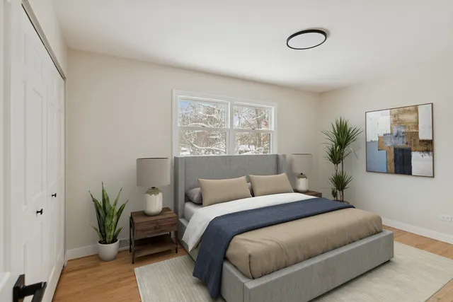 a bedroom with a bed and a potted plant