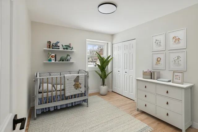 a spacious bedroom with a bed and a window