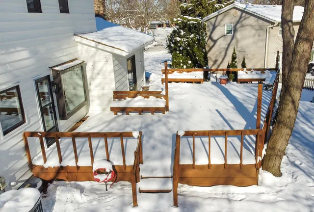 a view of a patio with table and chairs with wooden floor and fence