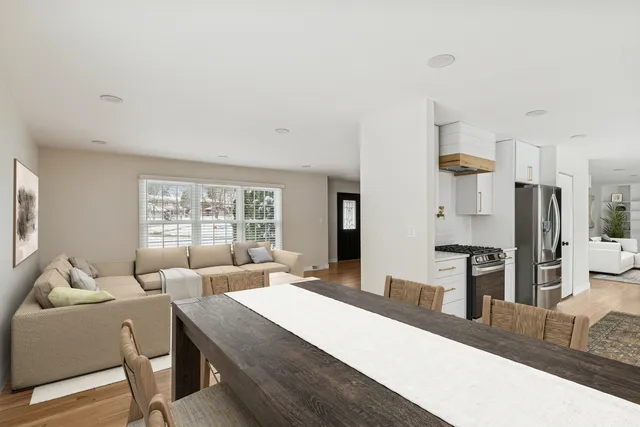 a large room with a large window and stainless steel appliances