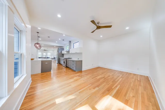 a large kitchen with stainless steel appliances lots of counter space and wooden floor