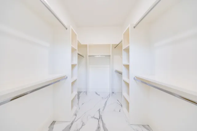 a spacious bathroom with a double vanity sink toilet mirror and bathtub