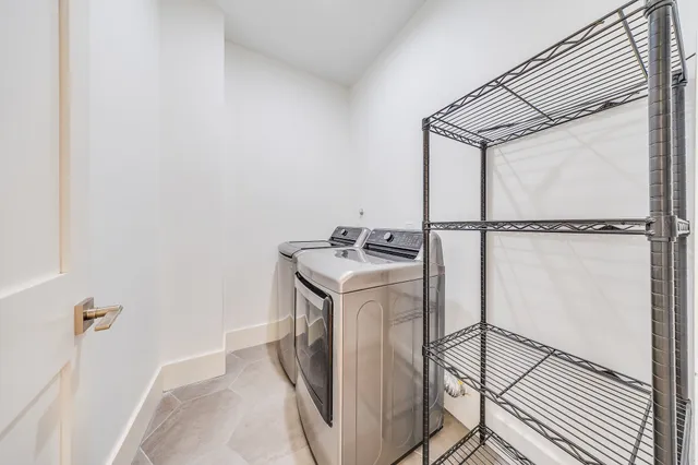 a bathroom with a toilet sink mirror vanity and shower